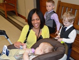 HCJFS Caseworker Leah Houchins greets Levi, 1, Westen, 3, and Aiden, 5, before their adoption Tuesday.
